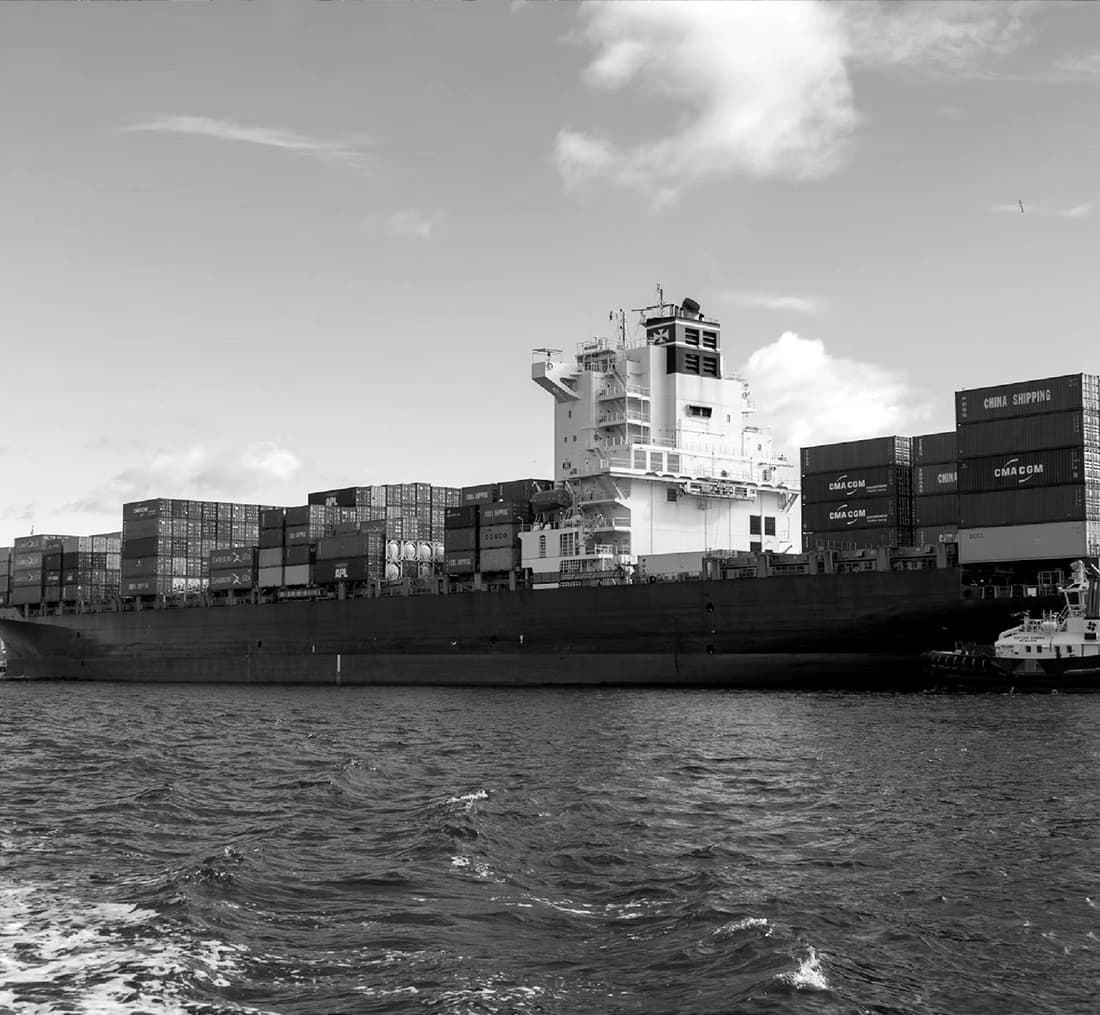 freight forwarding ship travelling across ocean with shipping containers