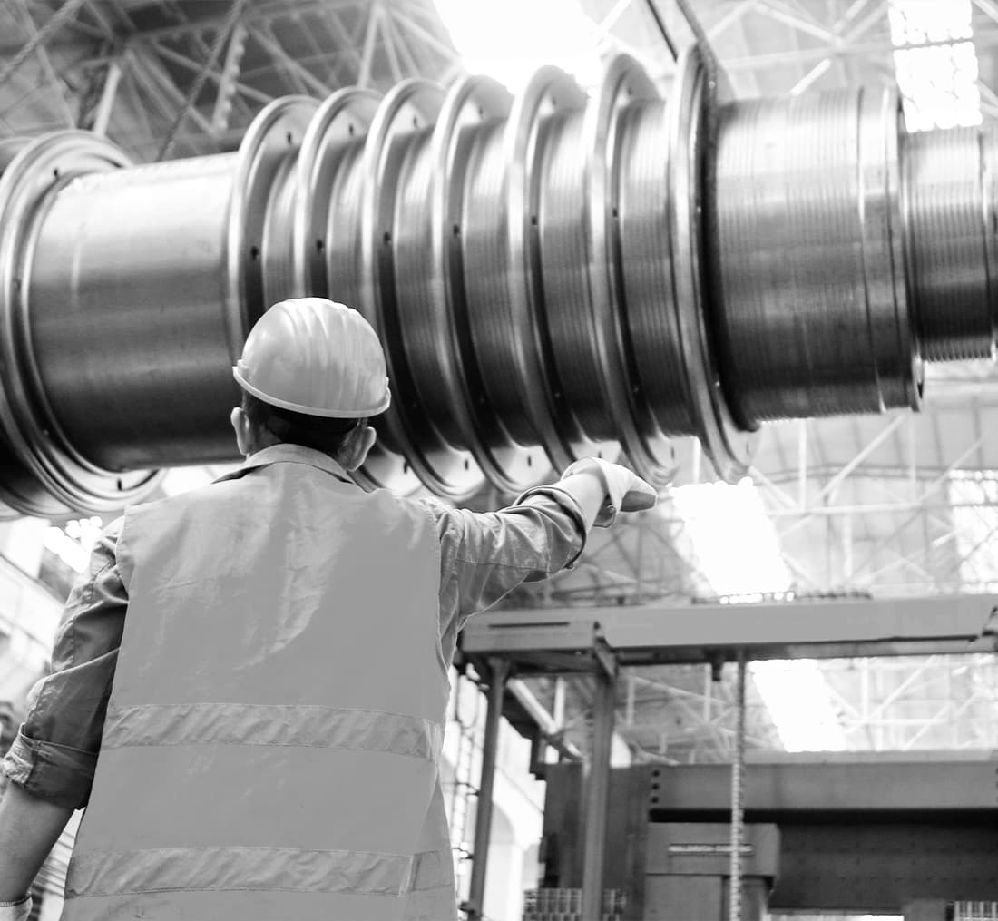 a worker in a factory using industrial mechanical equipment